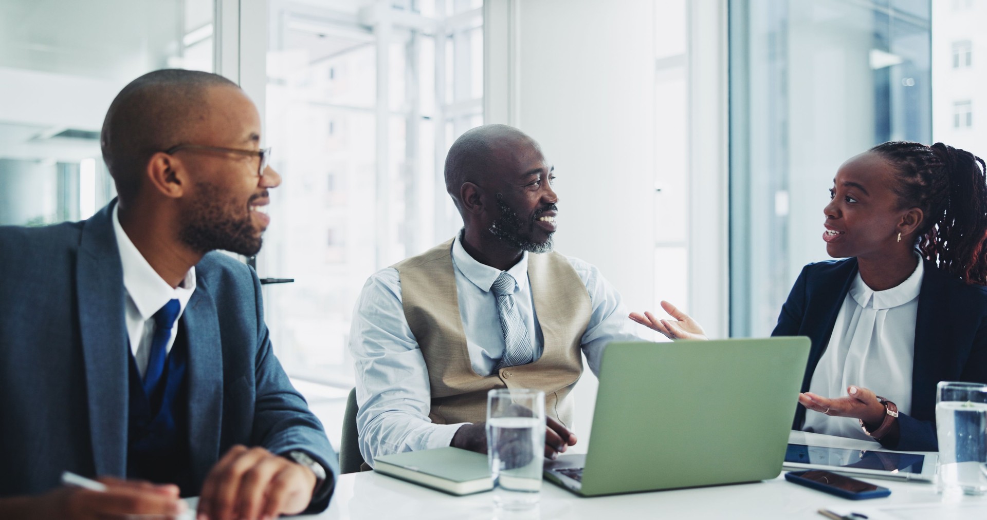 Partnership, black people and happy on laptop in office for ideas on project with teamwork and collaboration. Employee, smile and boardroom with research for planning and meeting as accountant